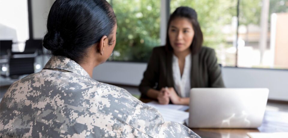 A military personnel consulting a legal professional about employment or military law issues during a legal consultation.