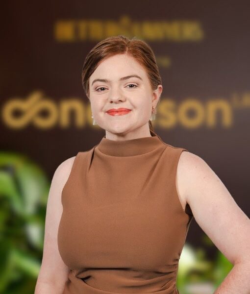 A professional woman standing confidently at Enterprise Legal office, showcasing legal expertise and professionalism in a modern environment.