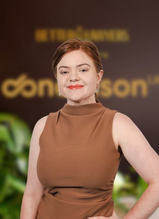 A professional woman standing confidently at Enterprise Legal office, showcasing legal expertise and professionalism in a modern environment.